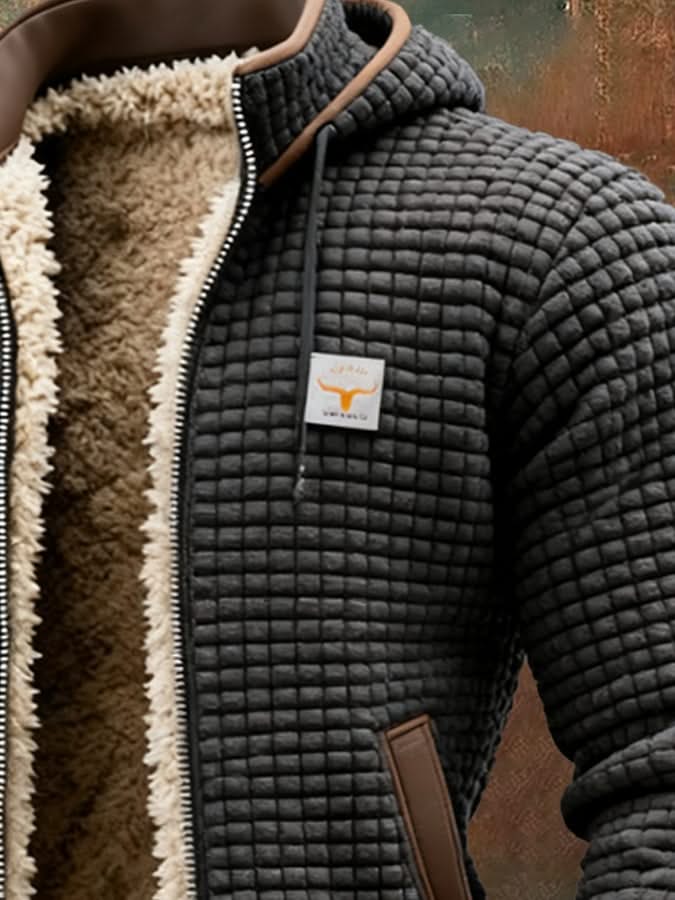 Black quilted fleece jacket with tan sherpa lining, chest logo patch, and zip front