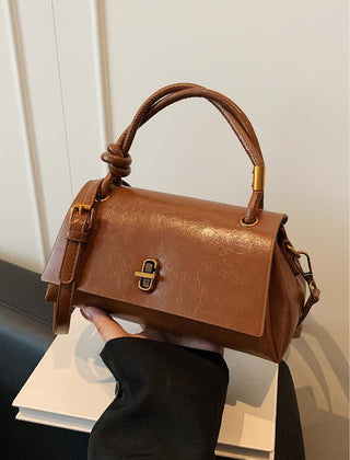 Cognac-brown leather-look crossbody shoulder bag with gold-tone clasp and top flap
