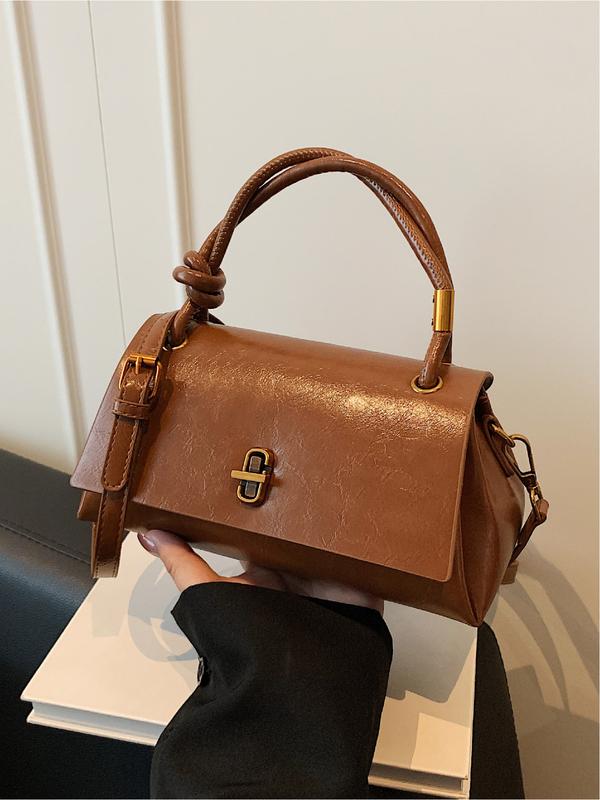 Cognac-brown leather-look crossbody shoulder bag with gold-tone clasp and top flap