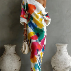 One-shoulder maxi dress in white with colorful abstract brushstroke print, draped sleeves