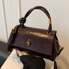 Brown leather-look crossbody shoulder bag with gold-tone clasp and top flap