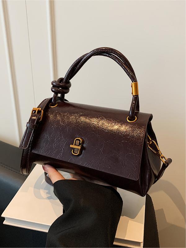 Brown leather-look crossbody shoulder bag with gold-tone clasp and top flap