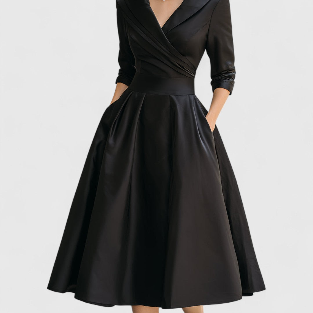 Black midi dress with surplice V-neck and three-quarter sleeves, flared pleated skirt