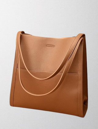 Brown vegan leather shoulder bag with curved front strap and top handles