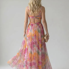Back view of multicolor sleeveless maxi wrap dress with open-back styling and tied waist.