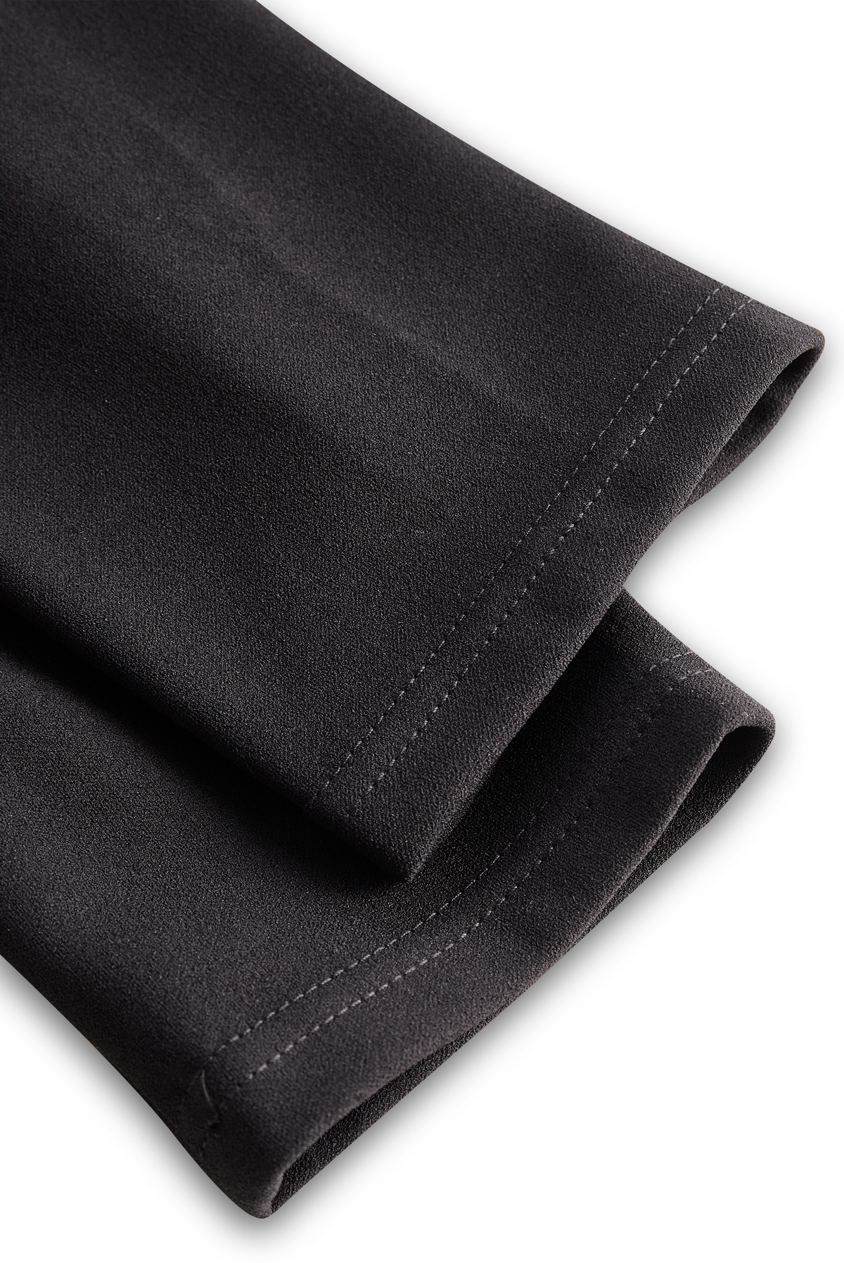 Black midi dress fabric with visible side seam stitching detail
