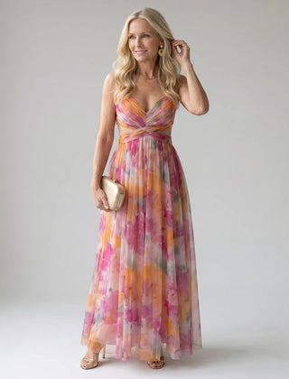 Multicolor maxi wrap dress with V-neck, sleeveless bodice, and twisted waist detail.