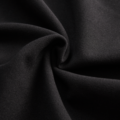 Black midi dress fabric close-up with smooth drape texture
