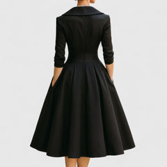 Black midi dress back view with fitted waist, flared skirt, and three-quarter sleeves