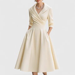 Beige midi dress with surplice V-neck, three-quarter sleeves, and pleated full skirt