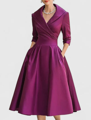Purple midi dress with surplice V-neck, three-quarter sleeves, and gathered full skirt