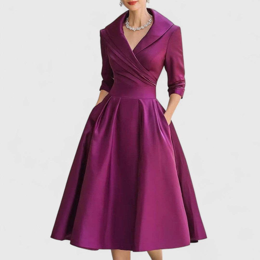 Purple midi dress with surplice V-neck, three-quarter sleeves, and gathered full skirt