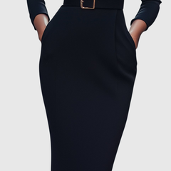 Fitted dark midi dress with waist belt and square gold buckle; long sleeves.