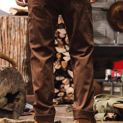 Brown straight-leg utility pants with dual thigh cargo pockets and cuffed hem