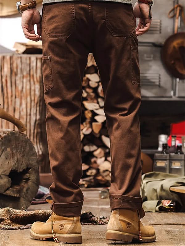 Brown straight-leg utility pants with dual thigh cargo pockets and cuffed hem