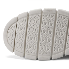 White rubber outsole with deep tread pattern and shock-absorbing flex grooves