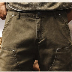 Army green utility pants close-up of waistband, button, and front fly