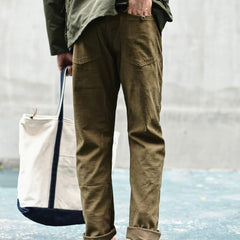 Olive straight fatigue pants with side and thigh pockets, cuffed straight hem