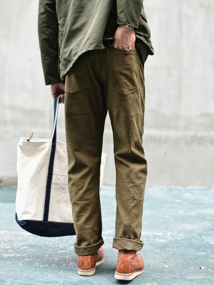 Olive straight fatigue pants with side and thigh pockets, cuffed straight hem