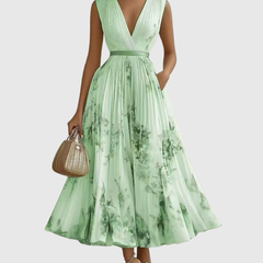 Green pleated maxi dress with V-neck, gathered waist and sleeveless bodice.