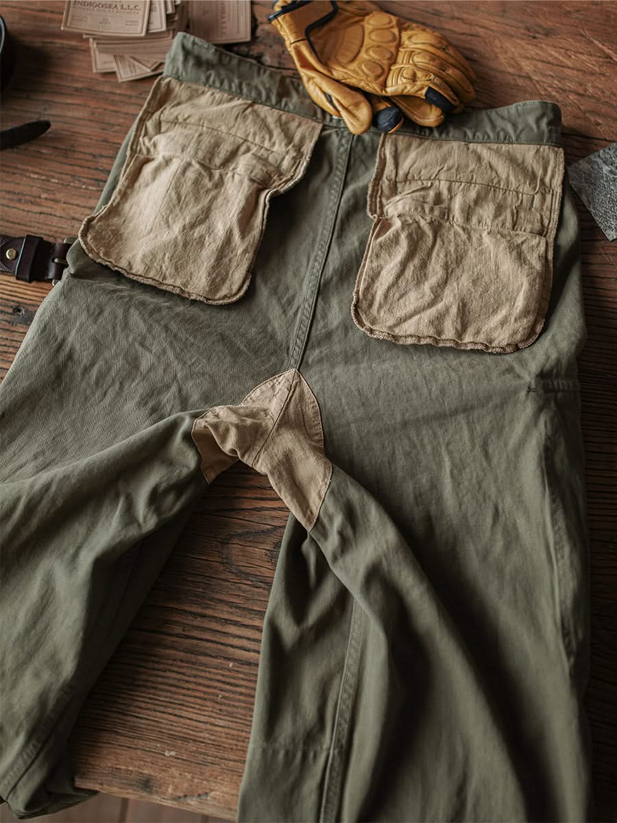 Army green M-47 HBT trousers with large cargo pockets and belt loops