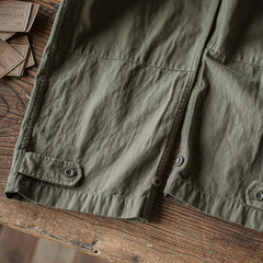 Army green M-47 HBT trouser leg with button tabs and stitched patch pockets
