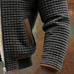 Black quilted fleece sleeve and pocket with brown trim and ribbed knit cuffs