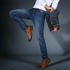 Men's stretch denim jeans, mid-blue wash, slim fit with front pocket leather patch