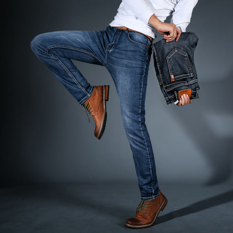 Men's stretch denim jeans, mid-blue wash, slim fit with front pocket leather patch