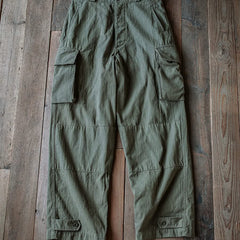 Army green cargo trousers laid flat, elastic waistband, side cargo flap pockets