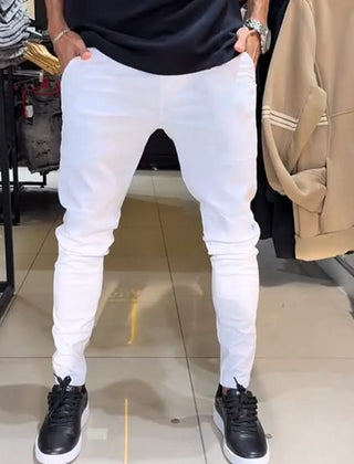 White slim trousers with tapered legs, button waist, and side pockets