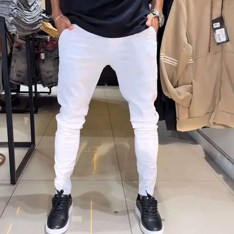 White slim trousers with tapered legs, button waist, and side pockets
