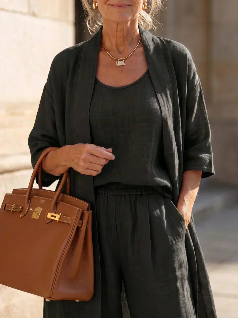 Black 3-piece outfit set close-up: scoop tank, elastic-waist wide-leg pants, kimono layer