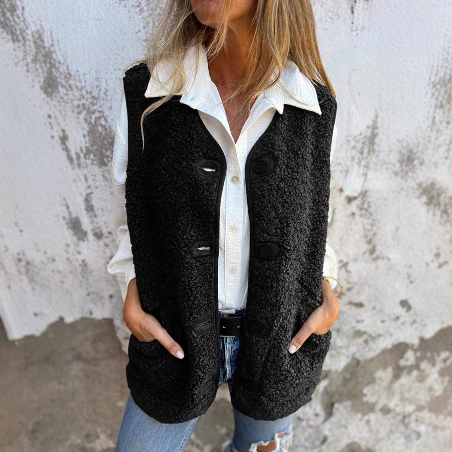 Etta women’s short warm vest in black, button-front with flap pockets.