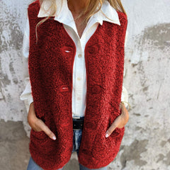 Etta women’s short warm vest in red, button-front with flap pockets.