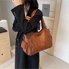 RAE Classic leather handbag, warm brown leather with front zip pockets and shoulder strap