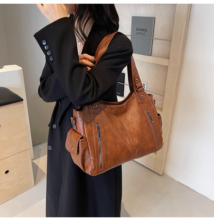 RAE Classic leather handbag, warm brown leather with front zip pockets and shoulder strap