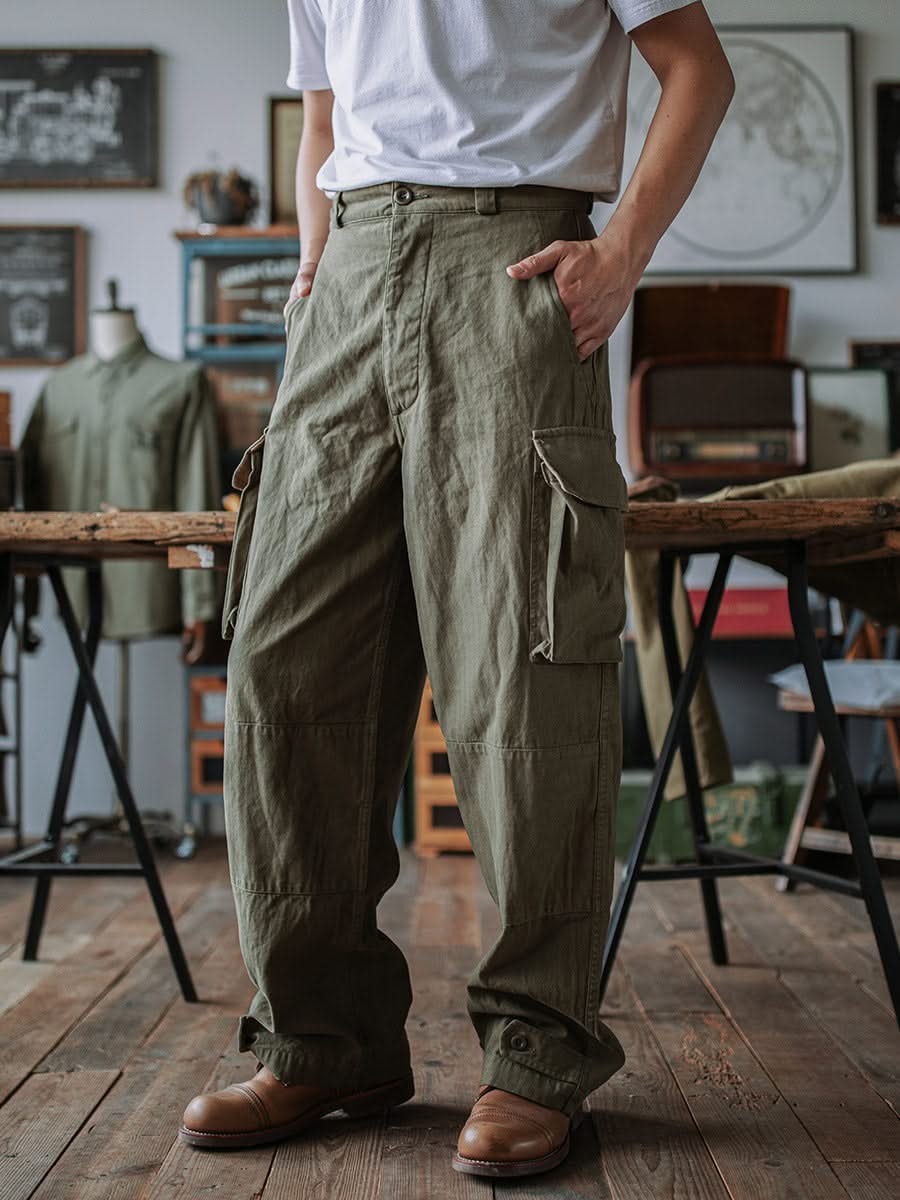 Army green cargo trousers with large flap side pockets and buttoned cuffs