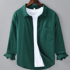 Green linen button-up shirt with point collar, chest pocket, and dark button placket