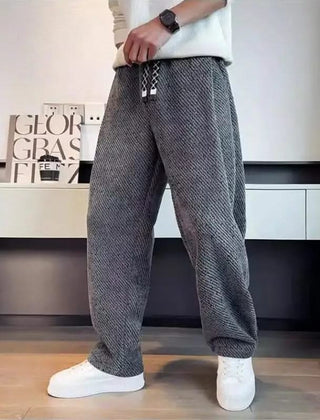 Grey textured tapered pants with elastic waistband and drawstring ties