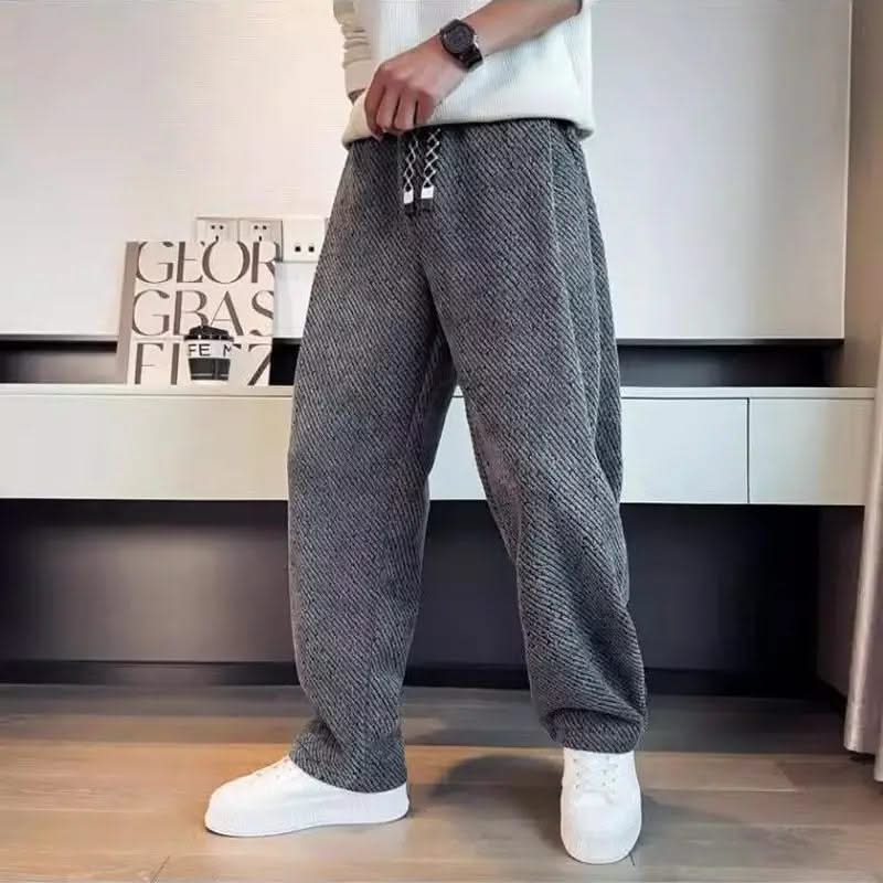 Grey textured tapered pants with elastic waistband and drawstring ties