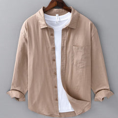 Camel beige button-up shirt with front placket and chest pocket, rolled sleeves