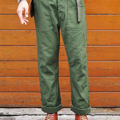 Olive green straight fatigue pants with front slash pockets and flap cargo pockets