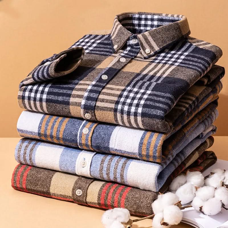 Stack of cotton flannel plaid shirts, mixed colors with button-up collars.