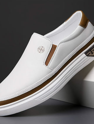 White slip-on shoes with brown trim, side gore panels, low profile rubber sole