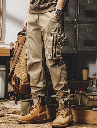 Khaki utility trousers with cargo pockets, drawstring waist, and button-flap details