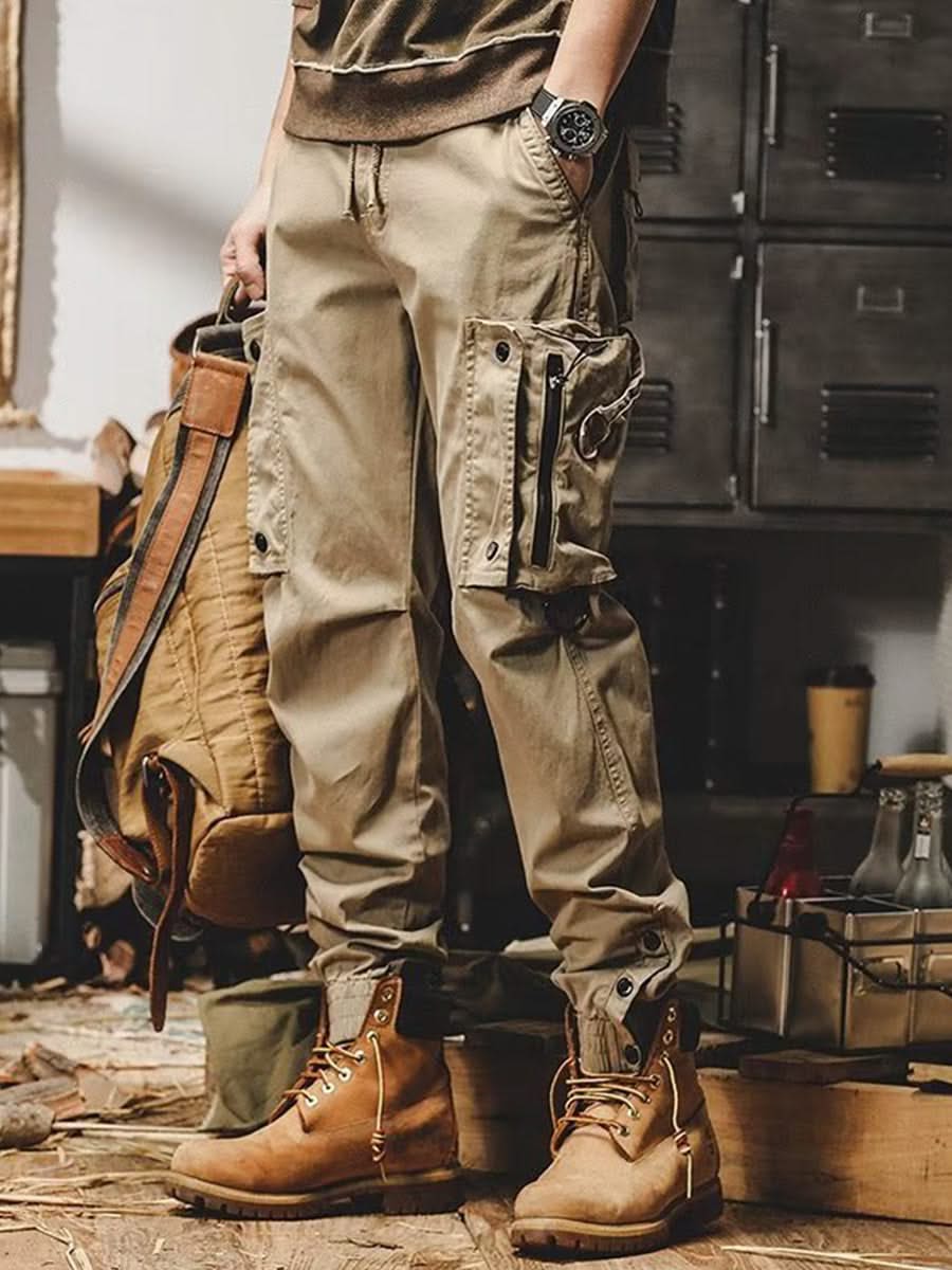 Khaki utility trousers with cargo pockets, drawstring waist, and button-flap details