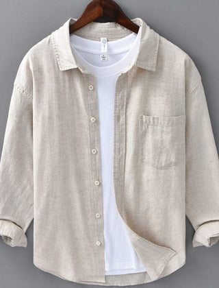Beige button-up shirt with front placket and chest pocket, rolled sleeves