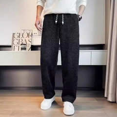 Black textured tapered pants with elastic waistband and drawstring ties