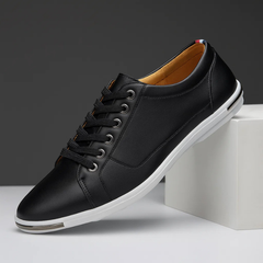 Black leather low-top sneaker with lace-up front and white rubber sole